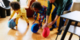 Children rolling Stapelstein® classic in super cool, red and blue