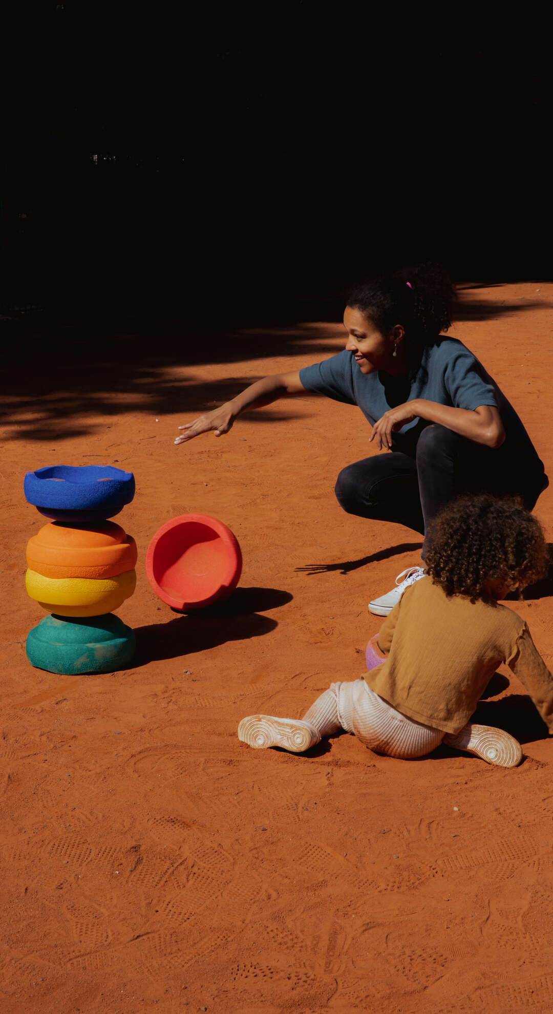 Women and child are playing with Original rainbow classic