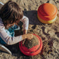 Child plays with stapelstein original warm classic in the sand